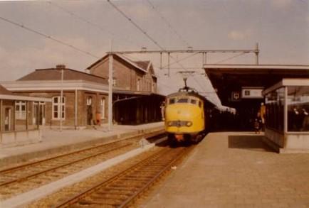Perron rechts, spoor, en links het stationsgebouw