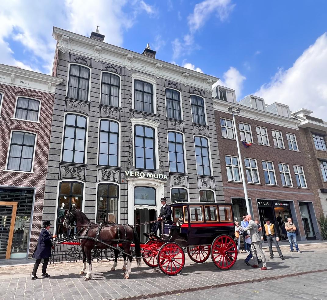 Een koets geparkeerd voor Grote Markt 17